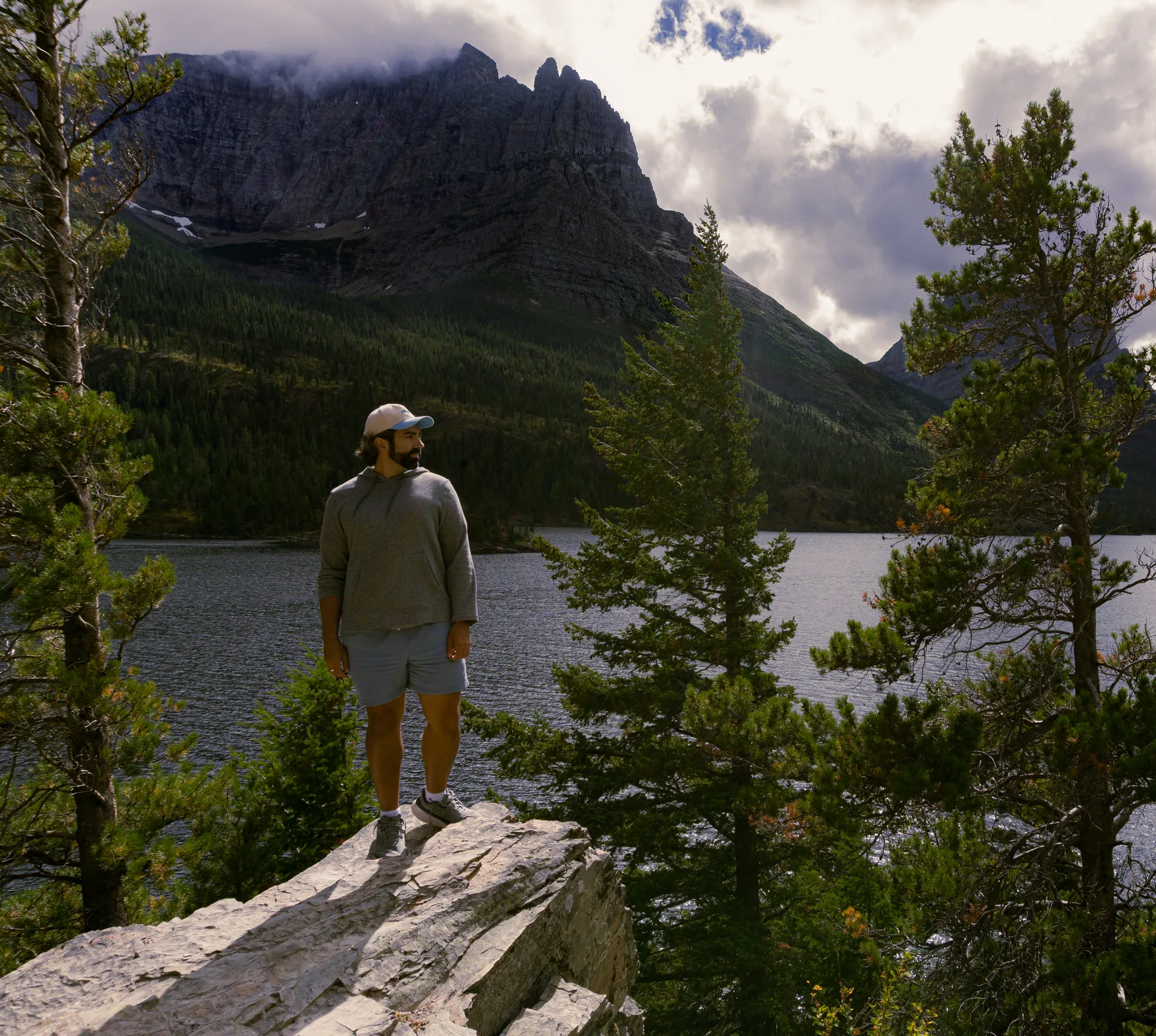 Joshua standing on a rock at the edge of a mountain lake